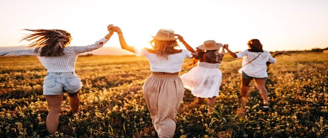 Girls having fun in meadow, walking and holding hands not affected by hay fever
