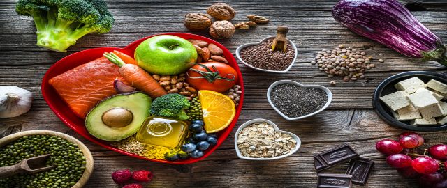 Cholesterol healthy foods flatlay on a wooden table