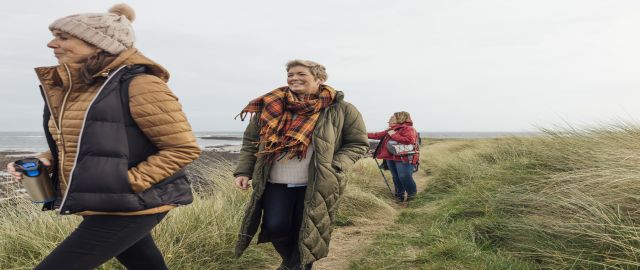 A wide angle front view of a group of four women exploring the coast. Exercise plays an impoirtant role in helping to protect both women and men from cardiovascular disease, but is especially helpful in addressing physiological changes associated with men