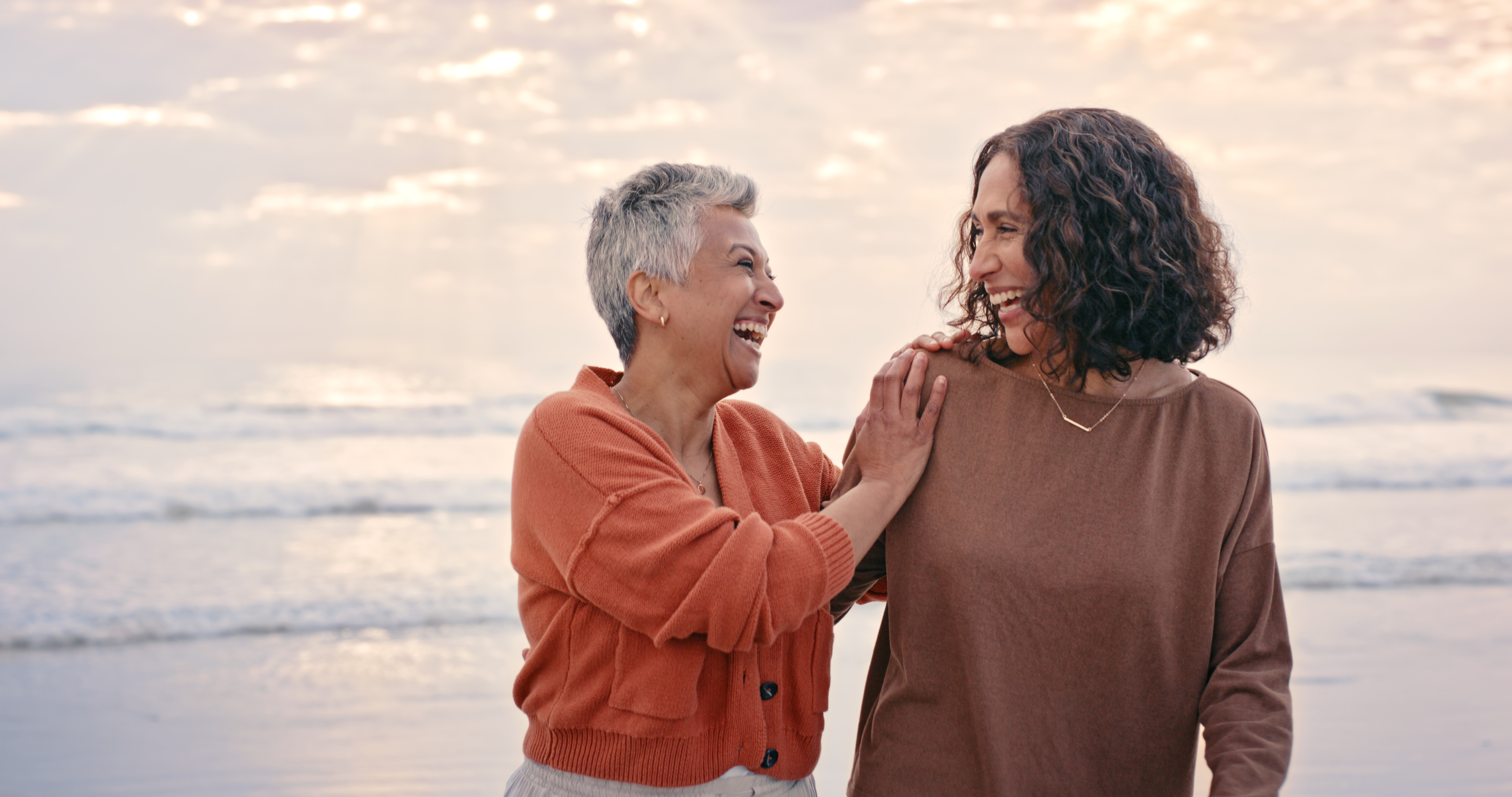 Making the menopause a positive experience. Two senior women at the beach enjoying a walk.